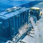 Power transformer secured on a low-bed trailer during a heavy cargo transport operation