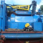 Close-up of heavy industrial equipment secured for transport on a modular trailer