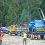 Tractor head transporting heavy industrial equipment on a modular multi-axle trailer