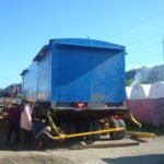 Large blue industrial module positioned on a modular multi-axle trailer