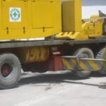 Close-up of a mobile crane outrigger deployed during an industrial lifting operation