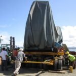 Covered oversized industrial equipment secured on a modular multi-axle trailer