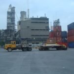 Tractor head and modular trailer positioned at an industrial facility